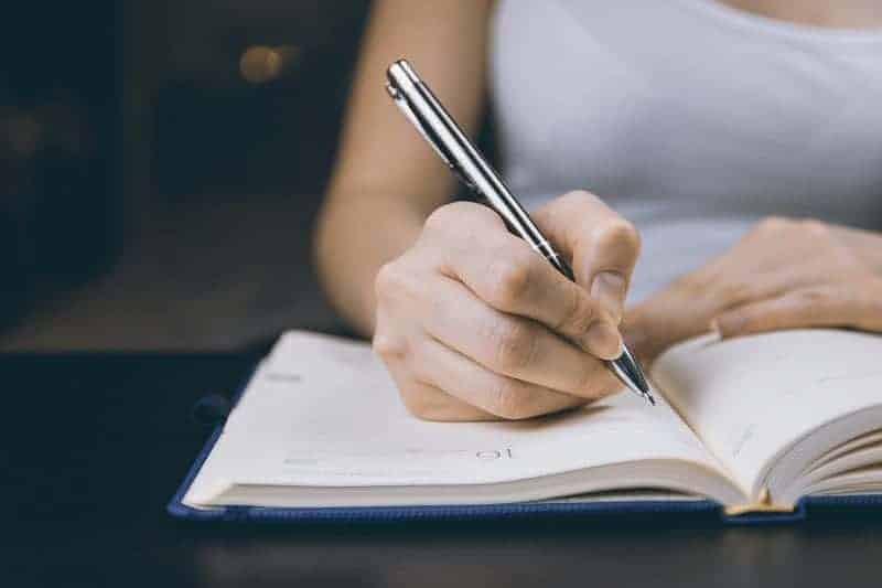 Woman writing in a notebook - FCE Writing